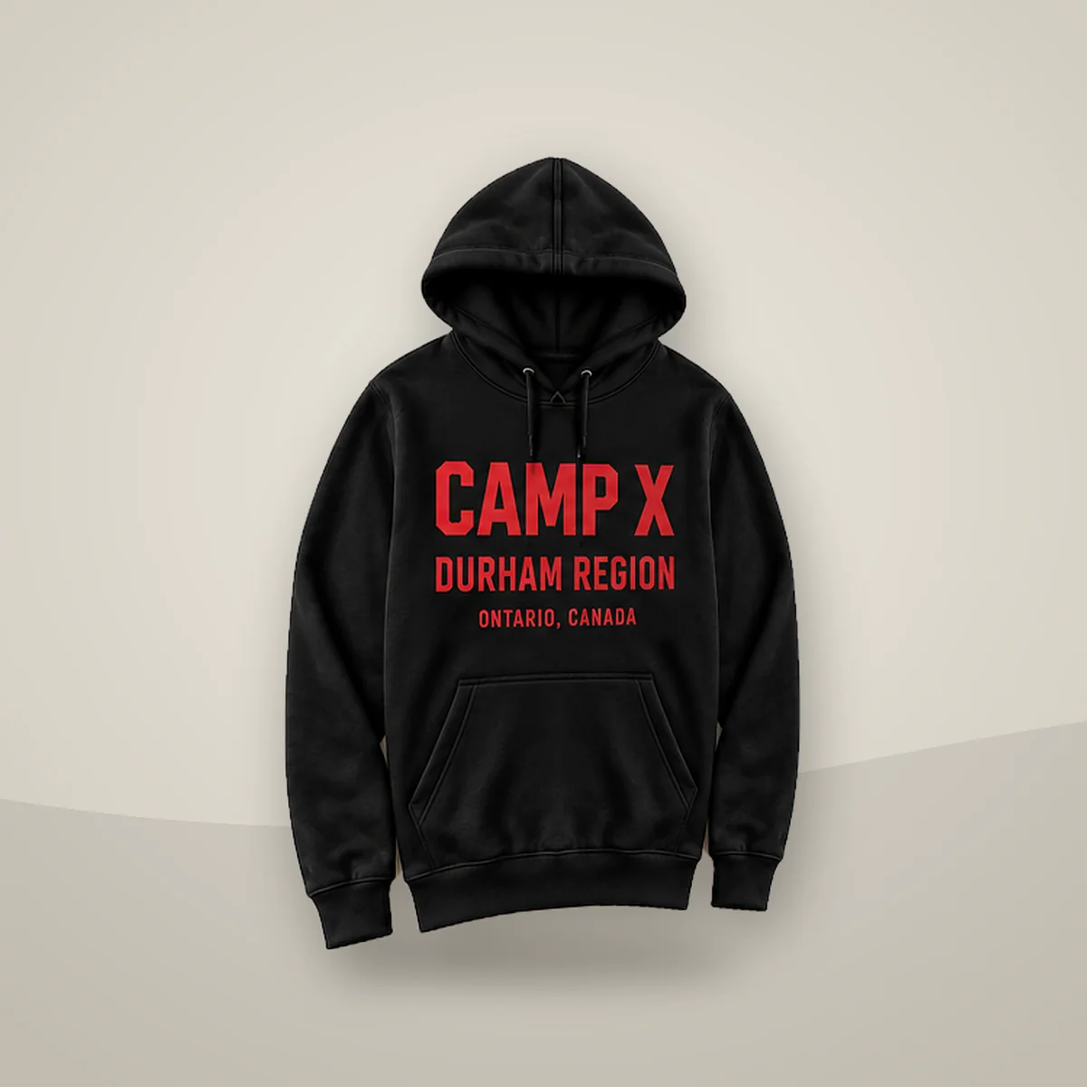 Camp X Durham Region Red Print Hoodie, angled view showing the red CAMP X Durham Region print