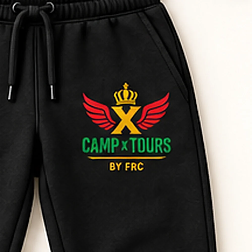 Close-up of the Camp X Tours by FRC emblem print on the leg of the Camp X Tours by FRC Cotton Tracksuit joggers